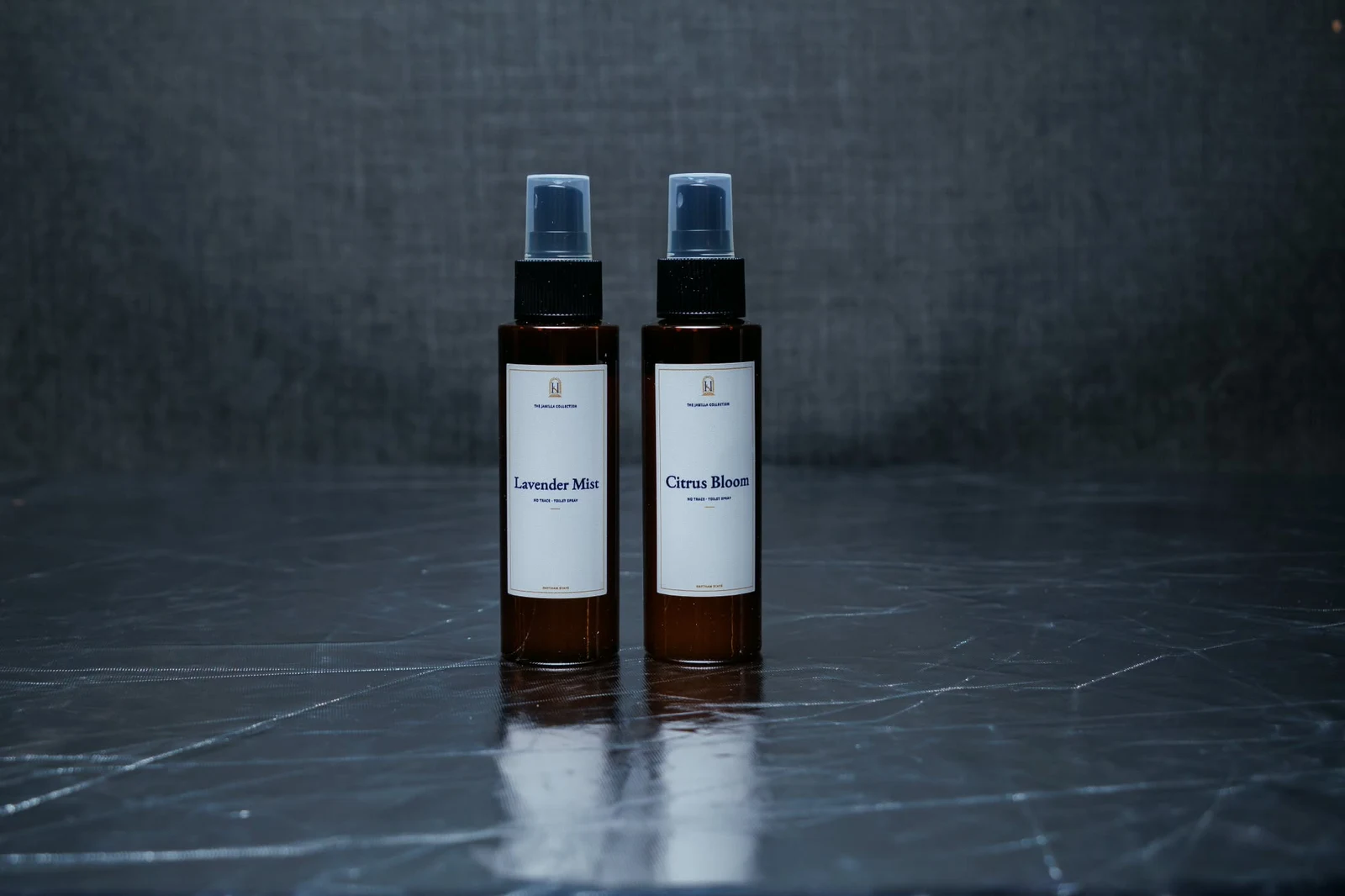 Lavender Mist and Citrus Bloom No Trace spray bottles with black caps and ivory Jamilla labels
