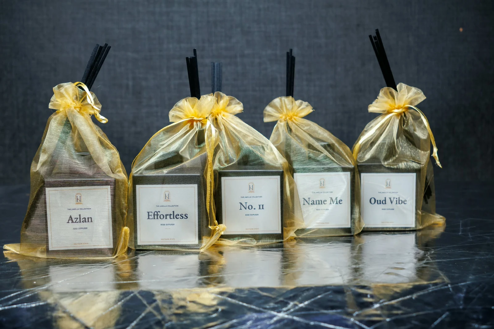 Five Jamilla reed diffusers in gift wrapping: Azlan, Effortless, No.11, Name Me and Oud Vibe
